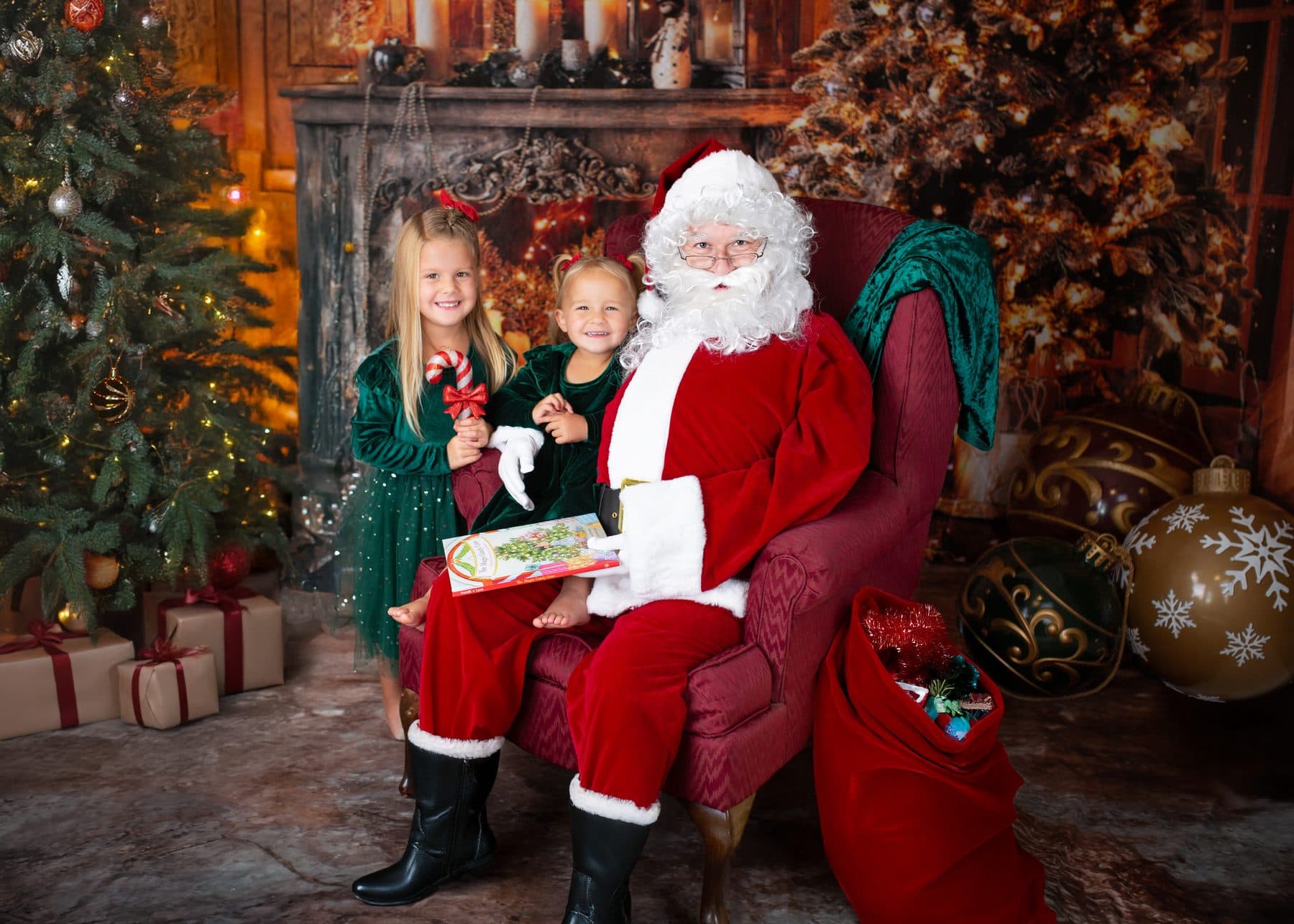 Two sisters visiting Santa by the fireside with The Magic Candy Cane